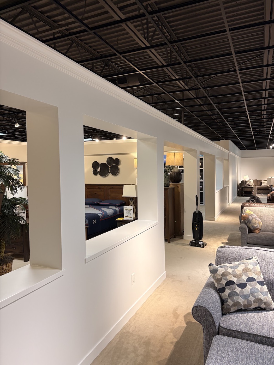 Commercial showroom interior with painted walls and exposed ceiling