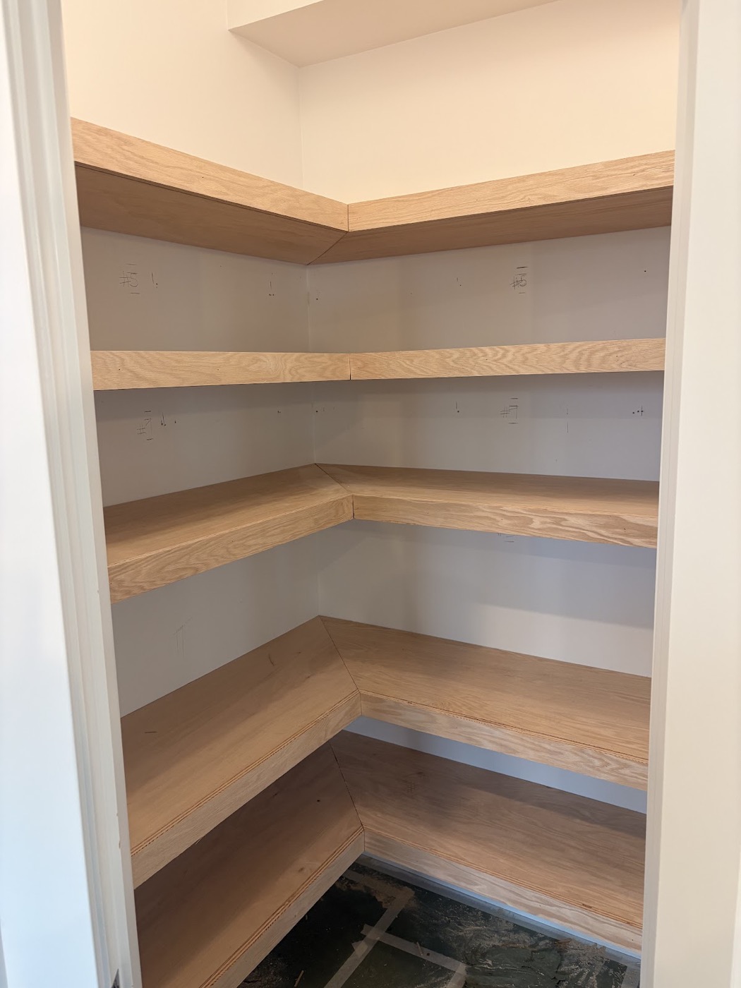 Built-in corner pantry shelving installed in a closet