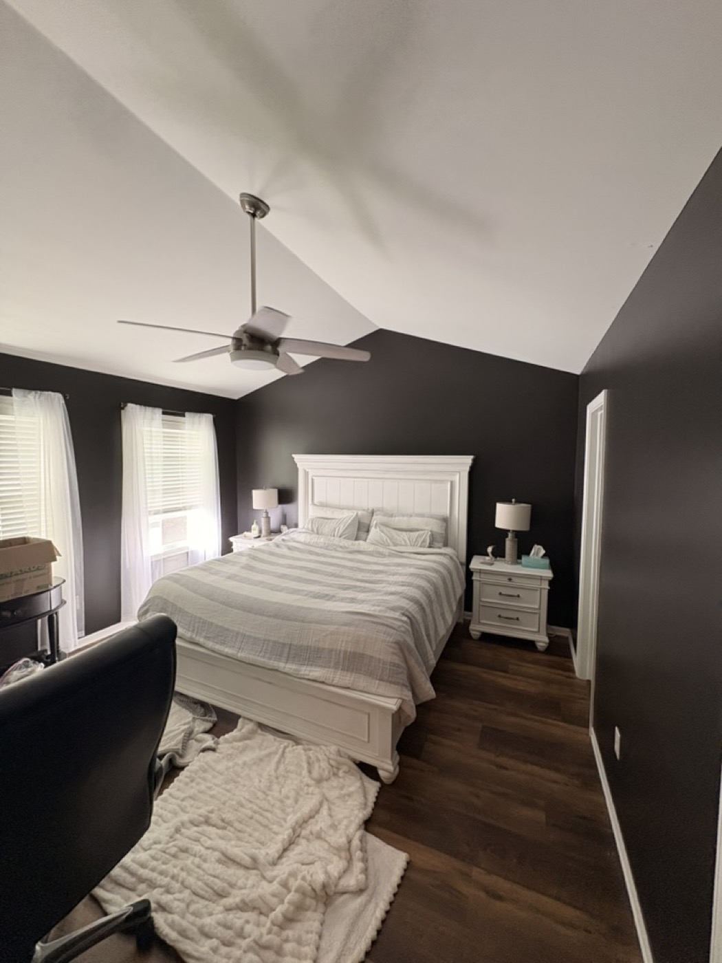 Bedroom with dark charcoal painted walls and white furniture