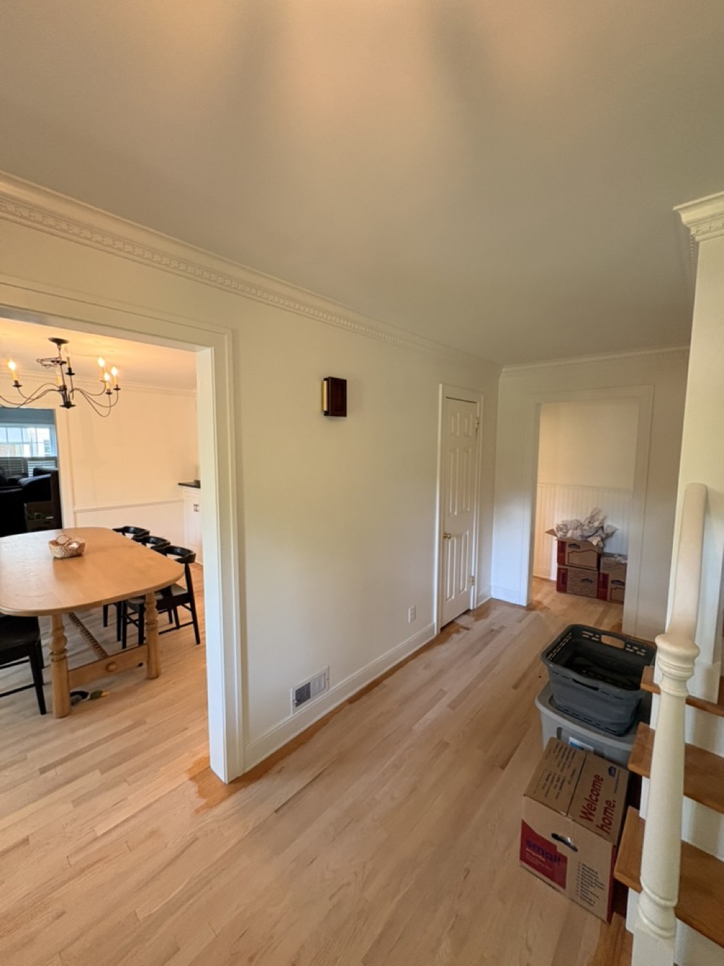 Hallway with taupe painted walls leading to a dining room