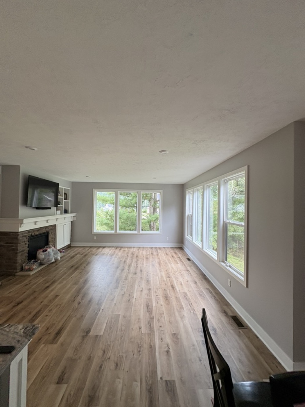 Living room with grey painted walls and a stone fireplace