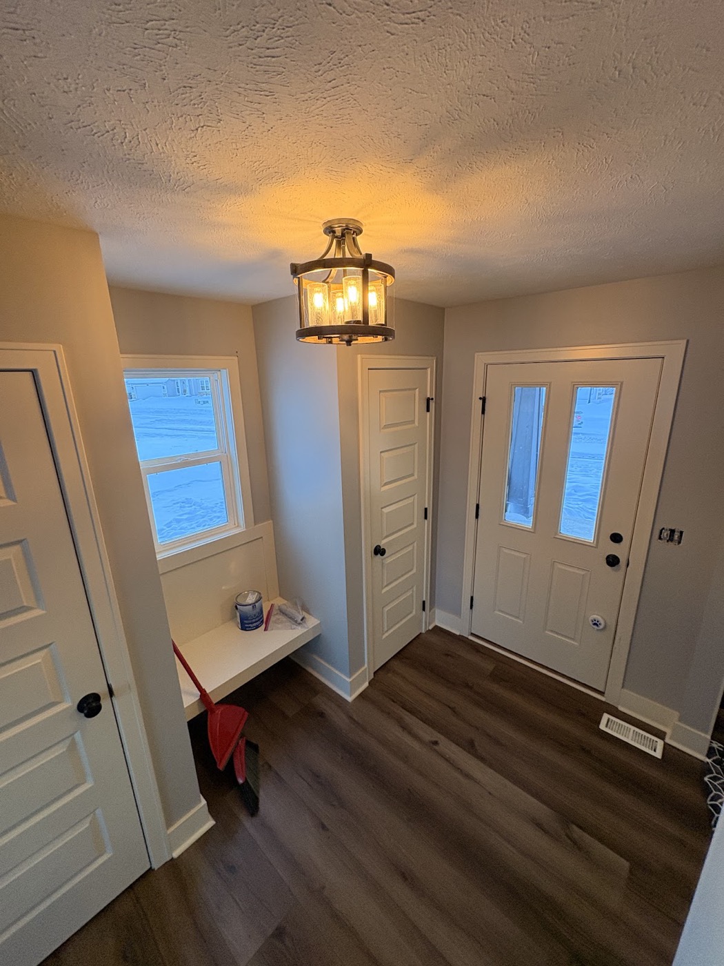 Painted entryway and mudroom with white doors and trim