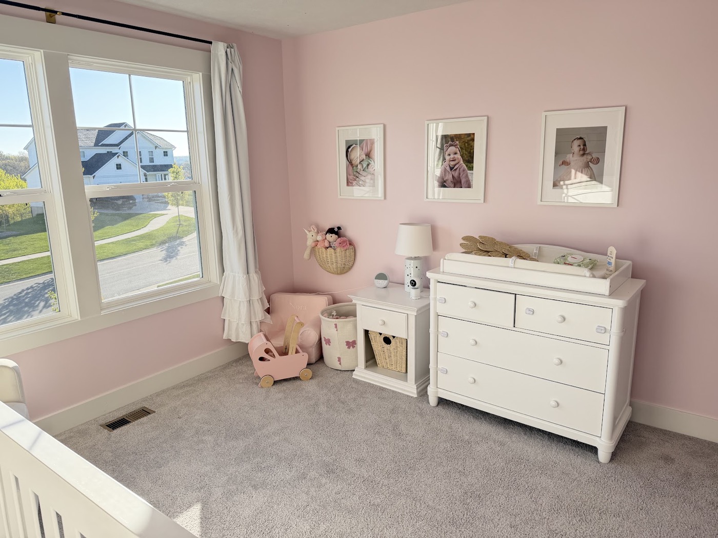 Furnished nursery with pink painted walls