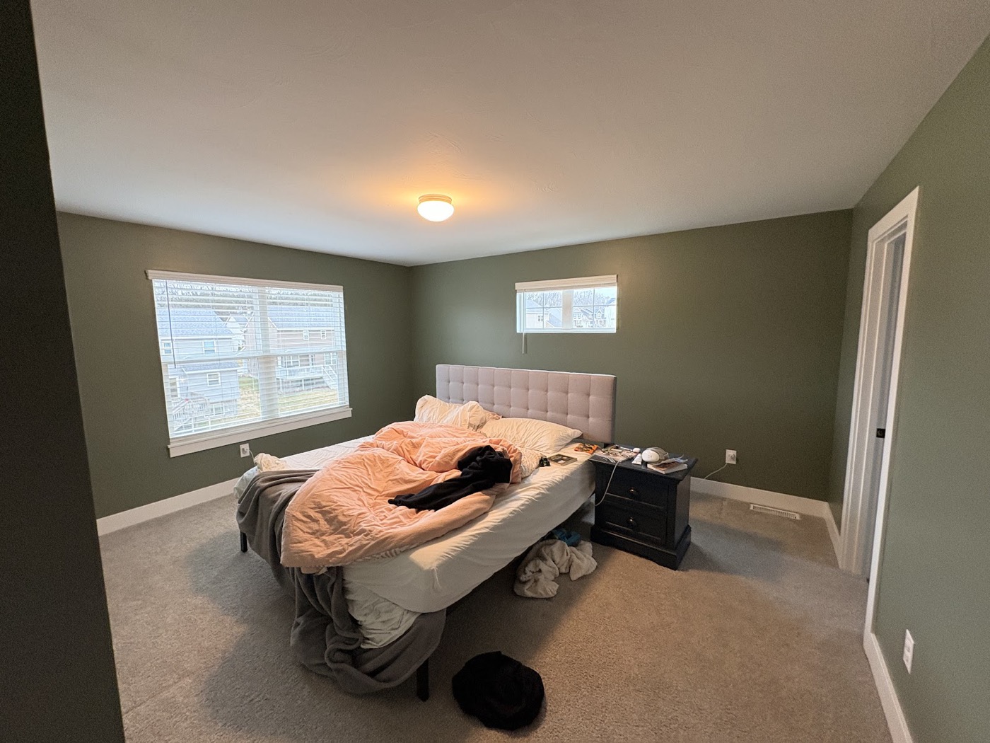 Furnished bedroom with sage green painted walls
